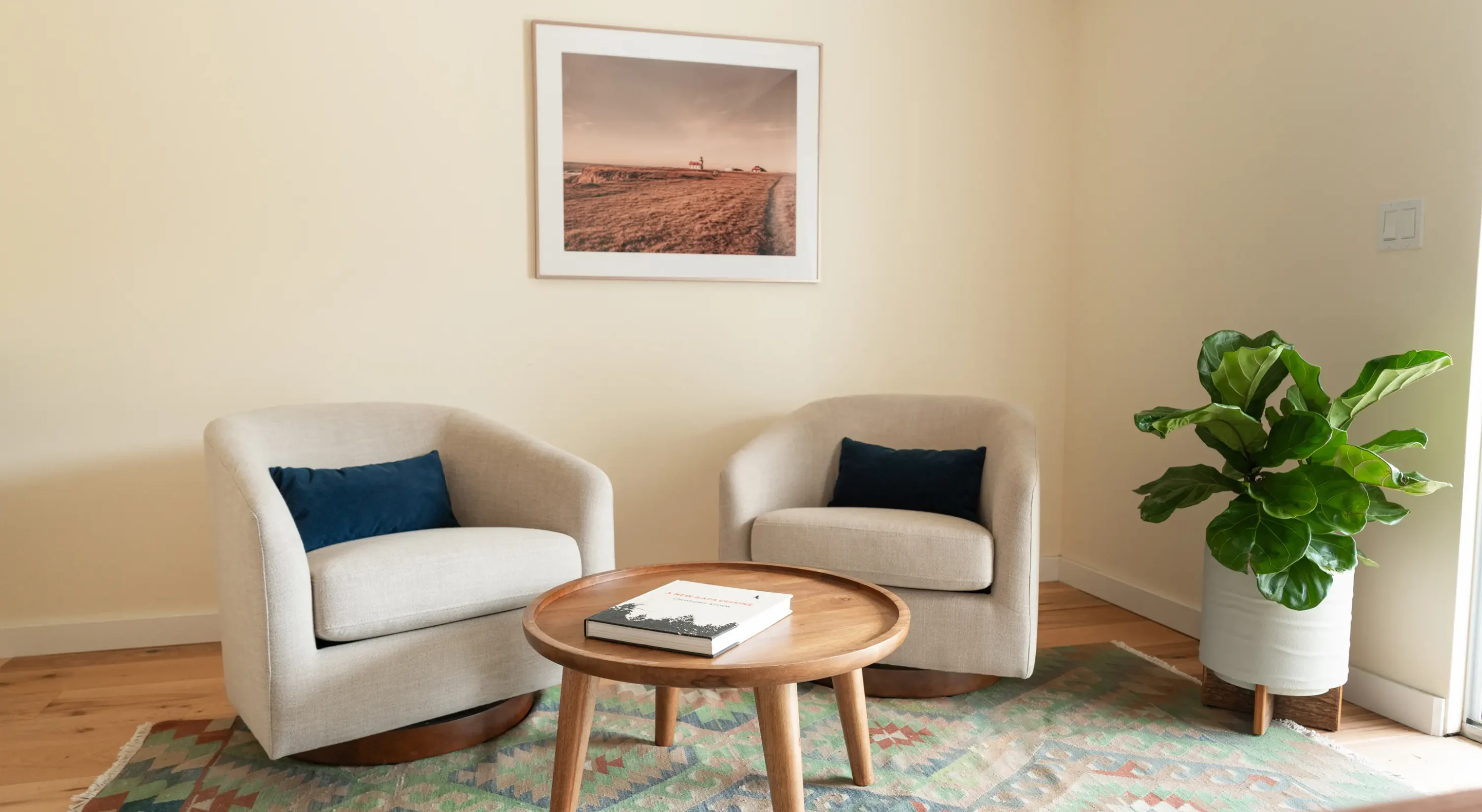 Seaside accommodations in Mendocino with two armchairs, wood coffee table, and indoor plant