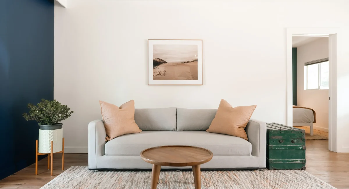 Mendocino Coast hotel suite living room with sofa, coffee table, and artwork