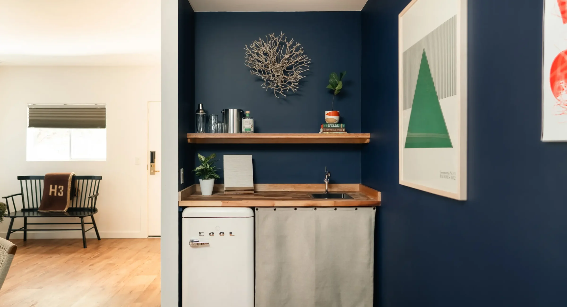 Mendocino Coast hotel suite kitchenette with mini fridge, sink, and modern shelving