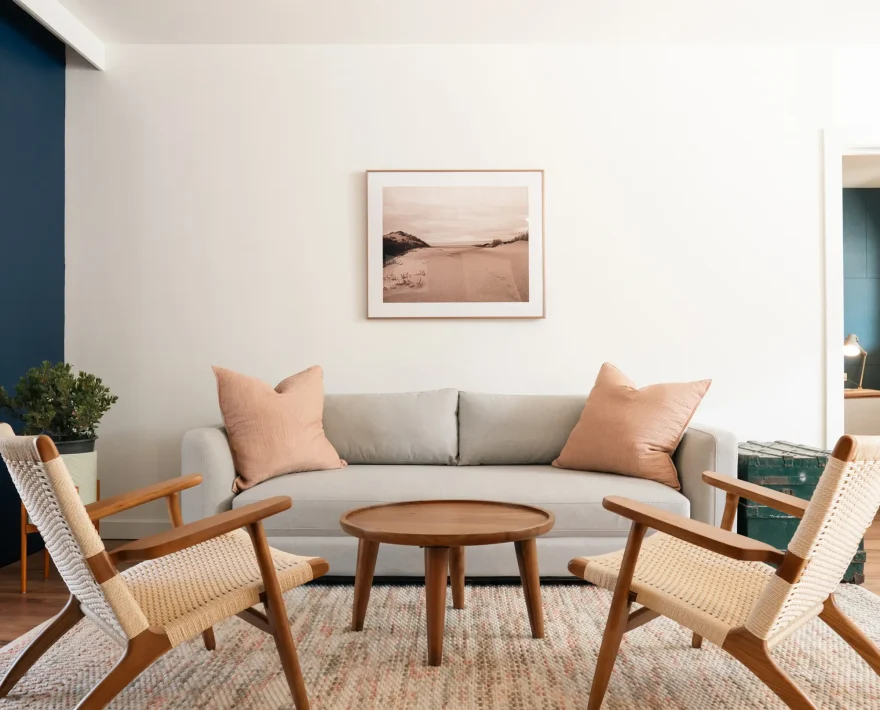 Seaside accommodations in Mendocino; suite featuring living room with sofa, lounge chairs, and round wood coffee table