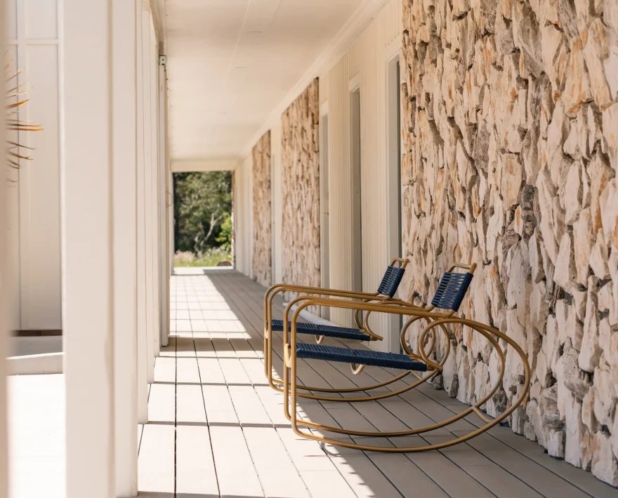 Covered walkway with rocking chairs outside guestrooms, top places to stay in Fort Bragg