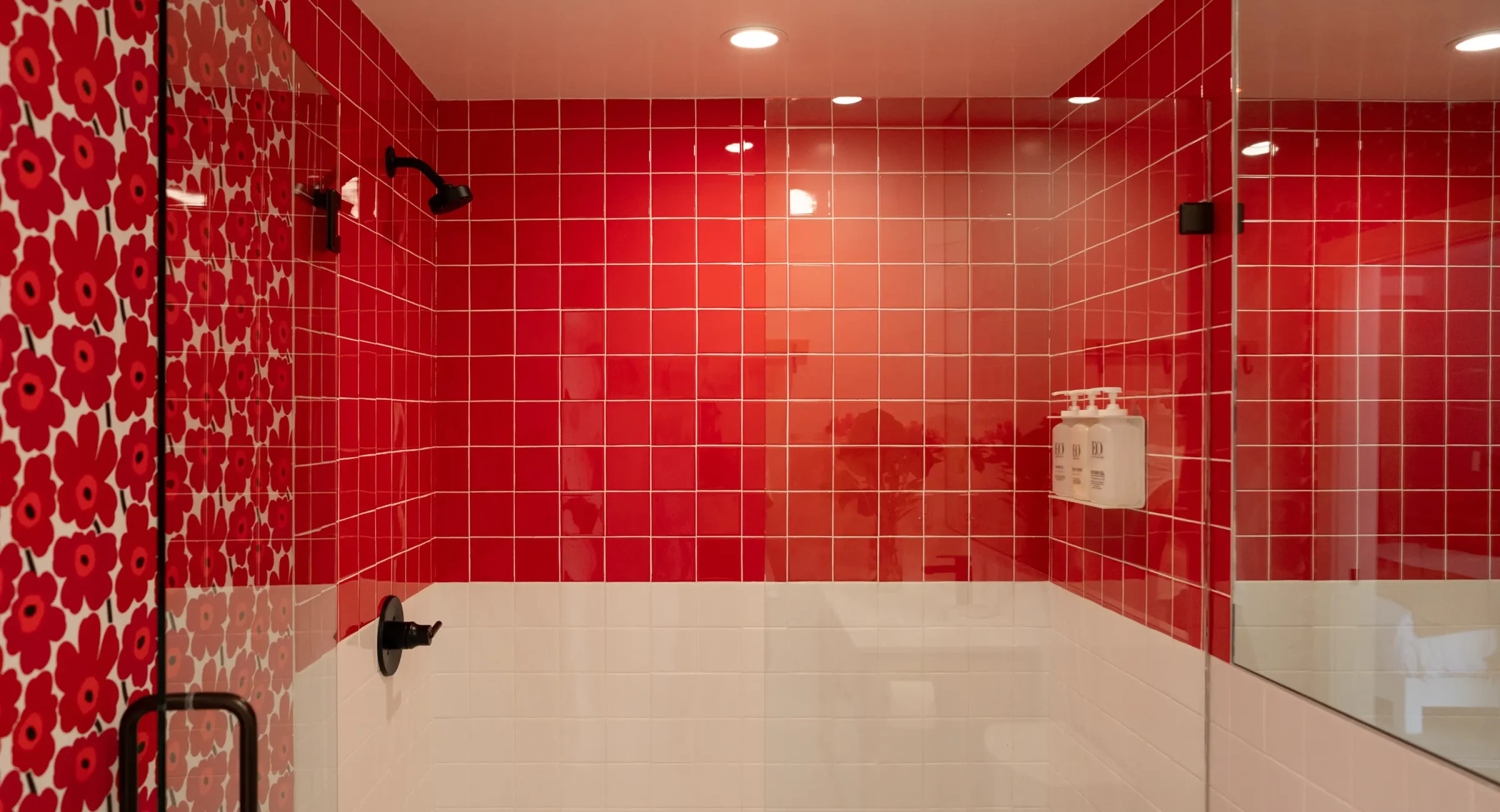 Mendocino hotel bathroom with red tile shower and floral accent wall