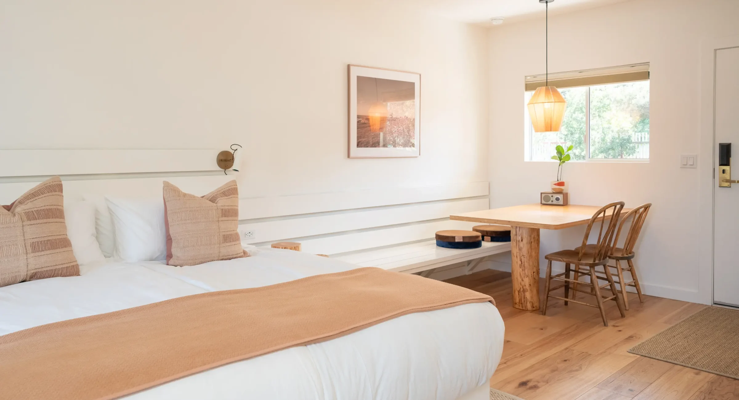 Spacious Mendocino Coast king room with bed, dining table, and natural wood furniture