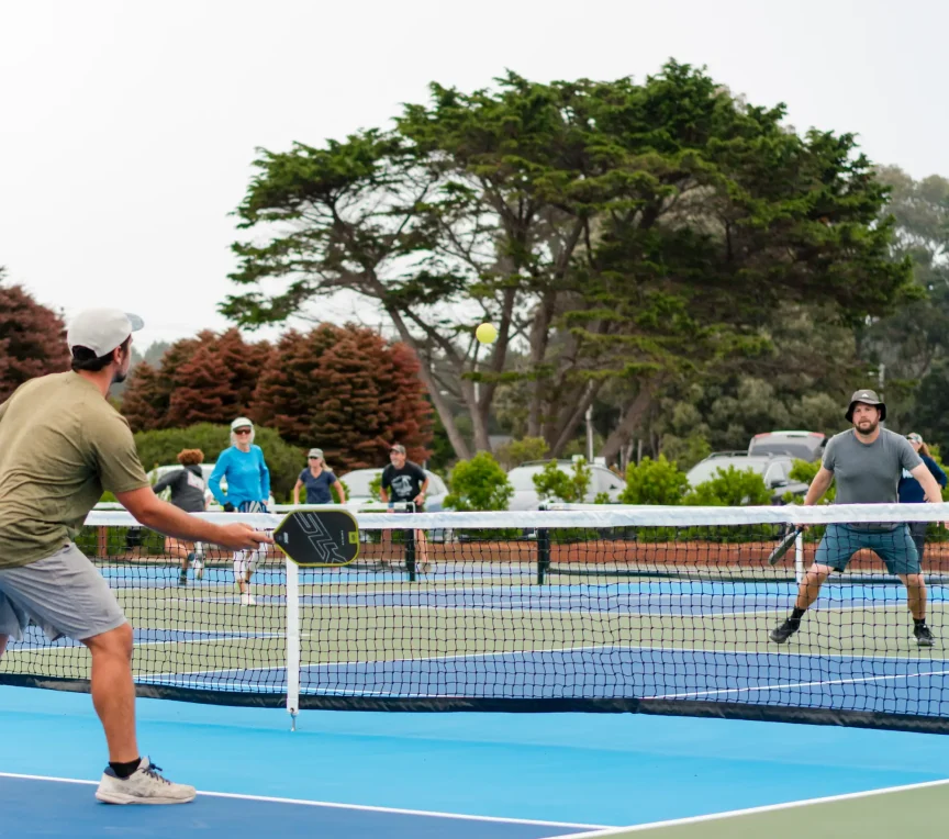 Action shot of pickleball play during Mendocino group retreat