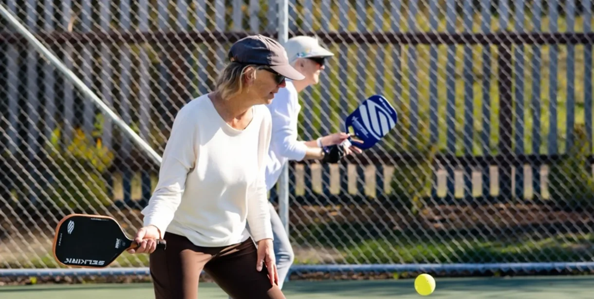 Couple learning pickleball