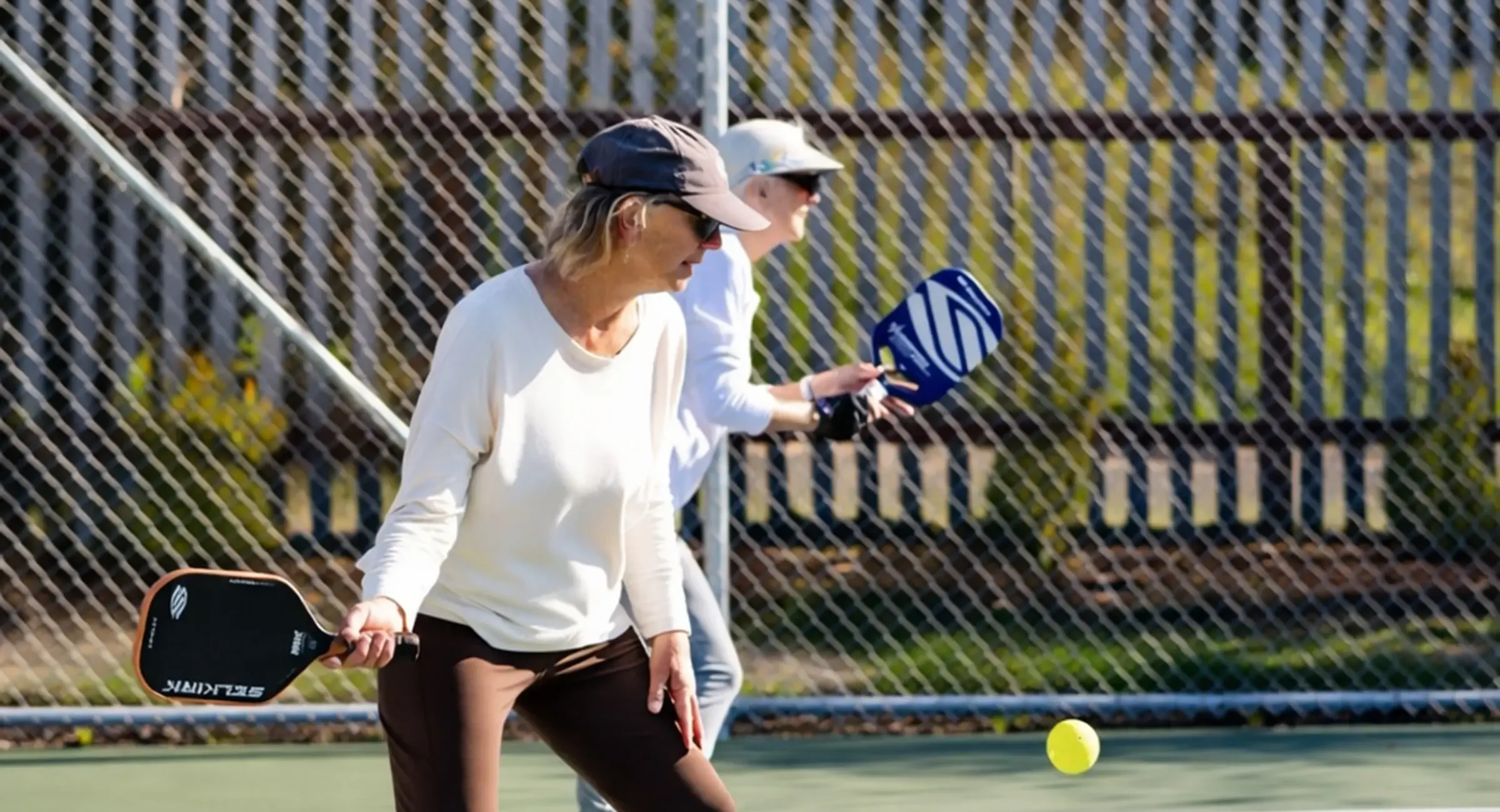 Couple learning pickleball